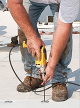 workman installing pvc roofing