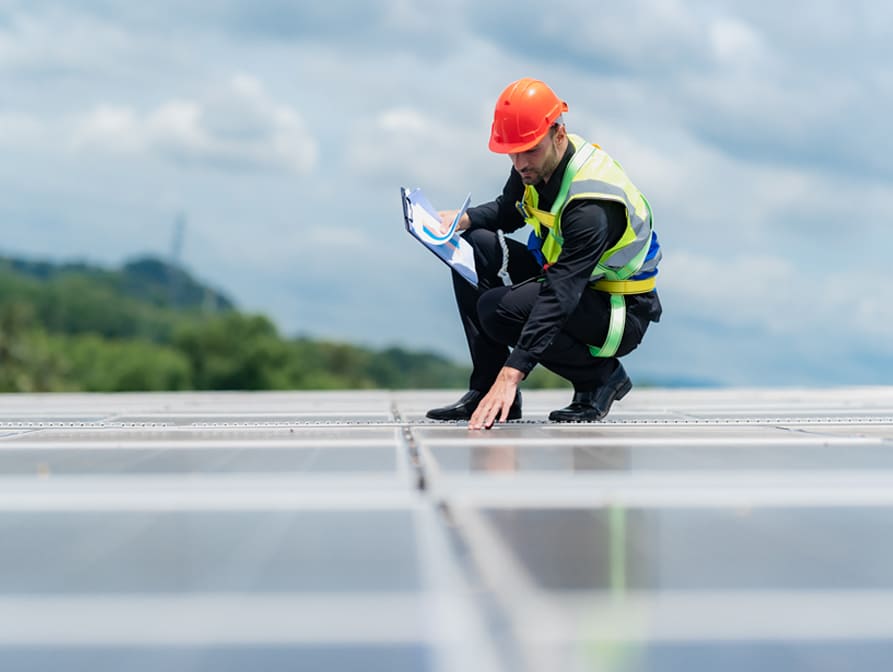 worker inspecting a commercial roof